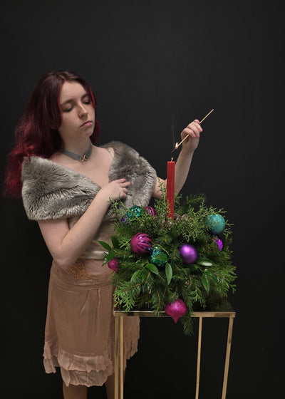 Christmas arrangement holiday decorative evergreen cedar pine fir Carolina sapphire foliage with colorful ornaments and candle