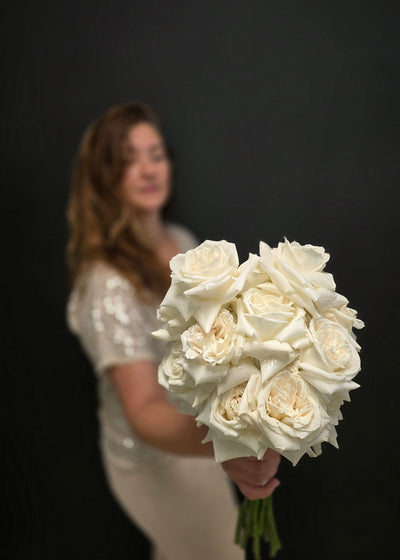 Bouquet of white roses bridal wedding girl holding reflexed