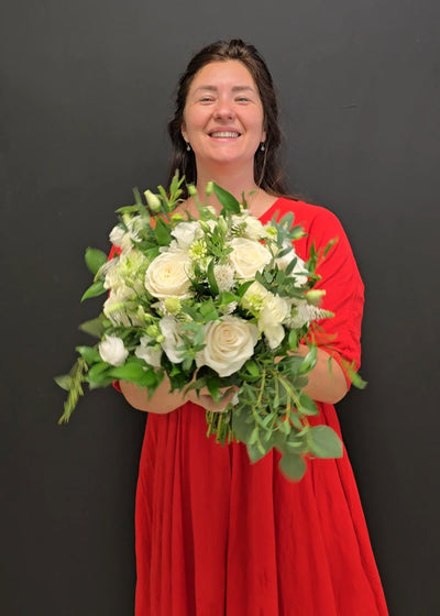 bride holding a wedding bouquet of fresh flowers white and green